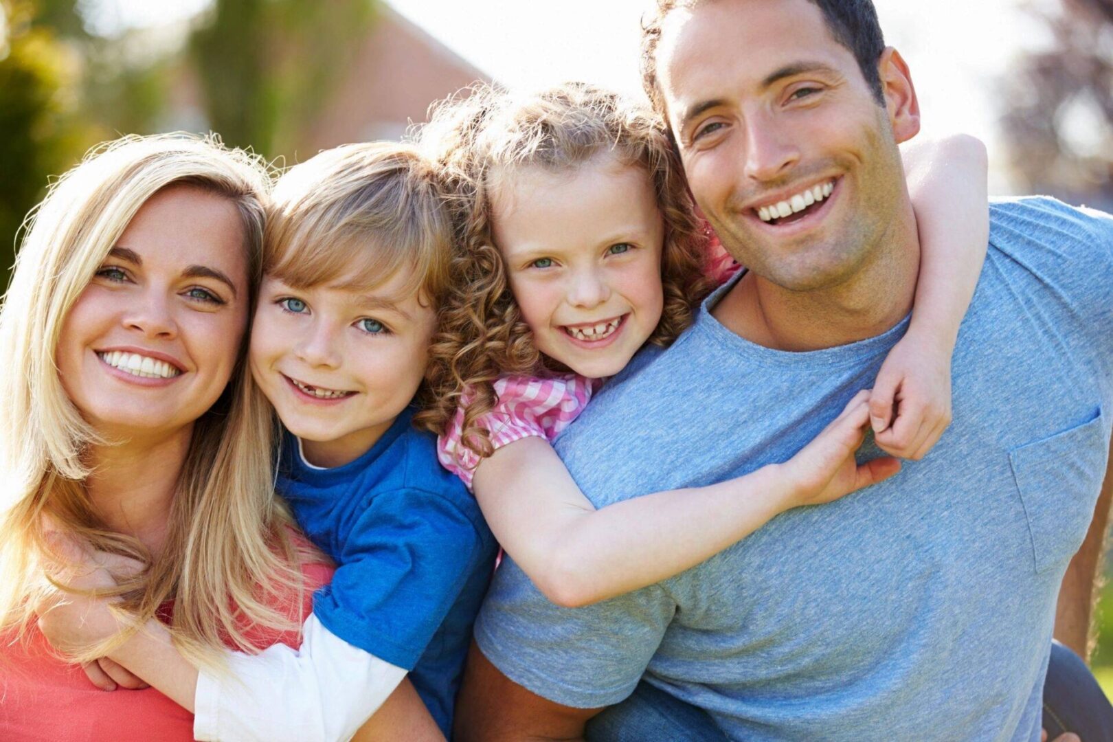 A family of four posing for the camera.